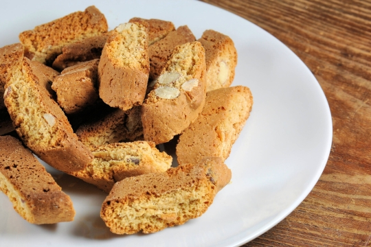 White plate piled with lots of Tuscan biscotti cookies